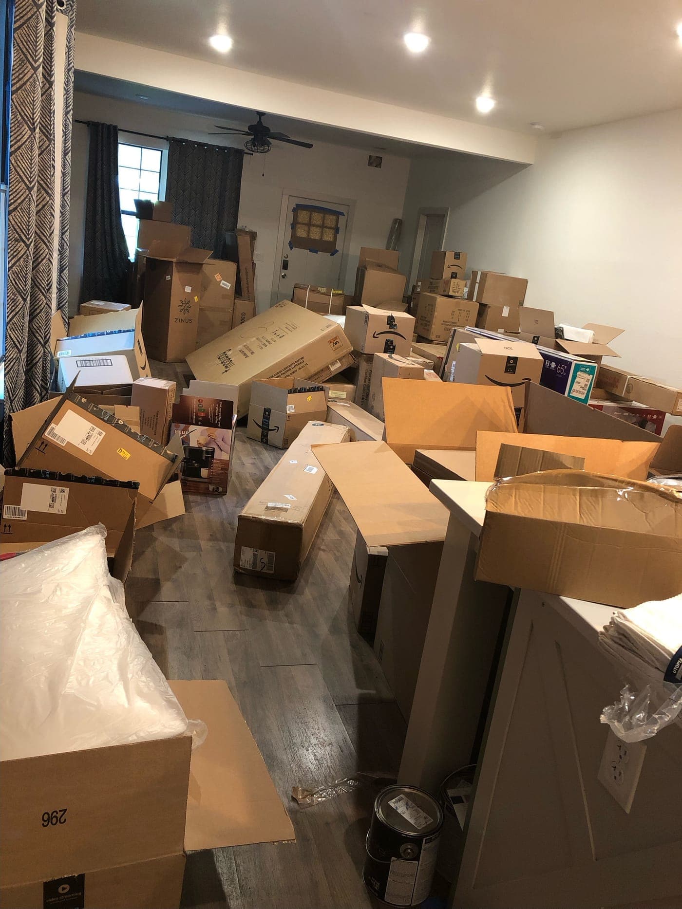 Living room filled wall to wall with shipping boxes